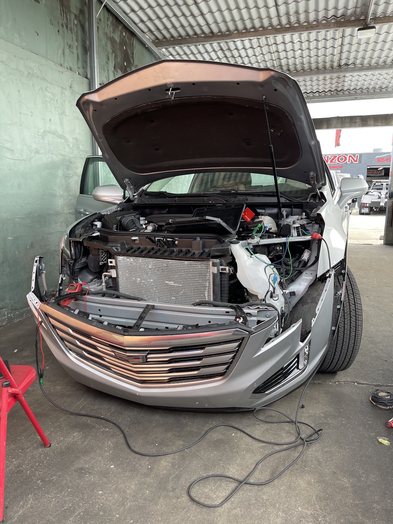 Exotic sports car on a vehicle lift in a clean, organized shop environment